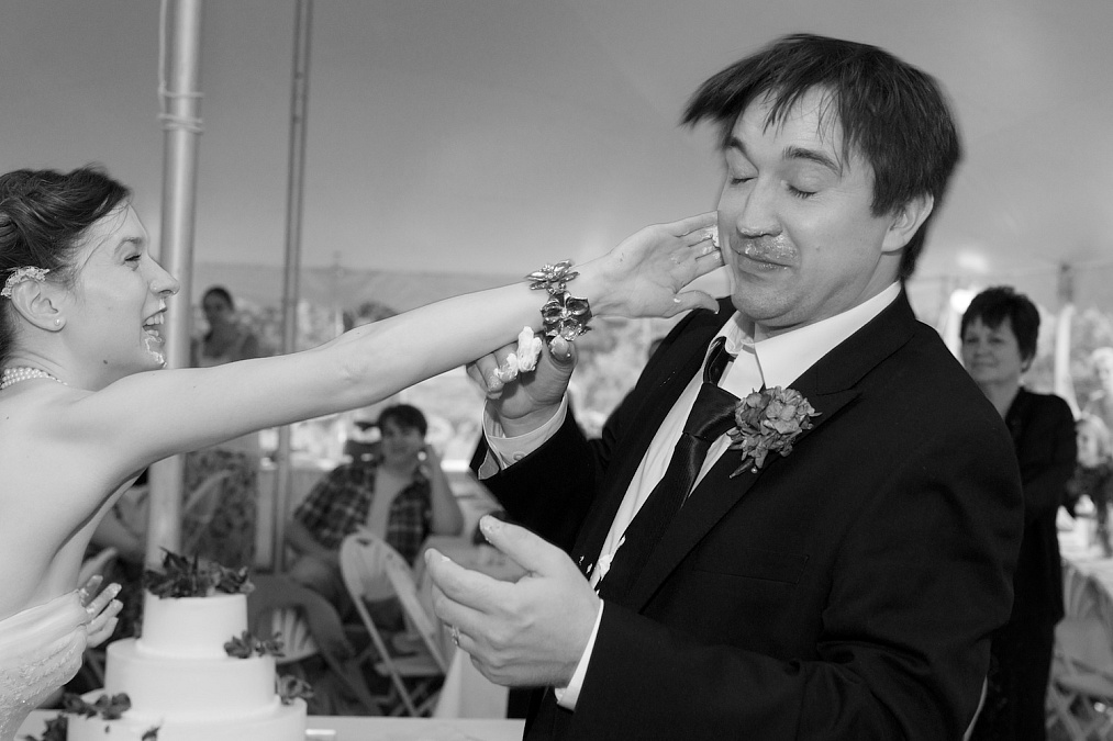 Candids of the cake cutting during their wedding reception.